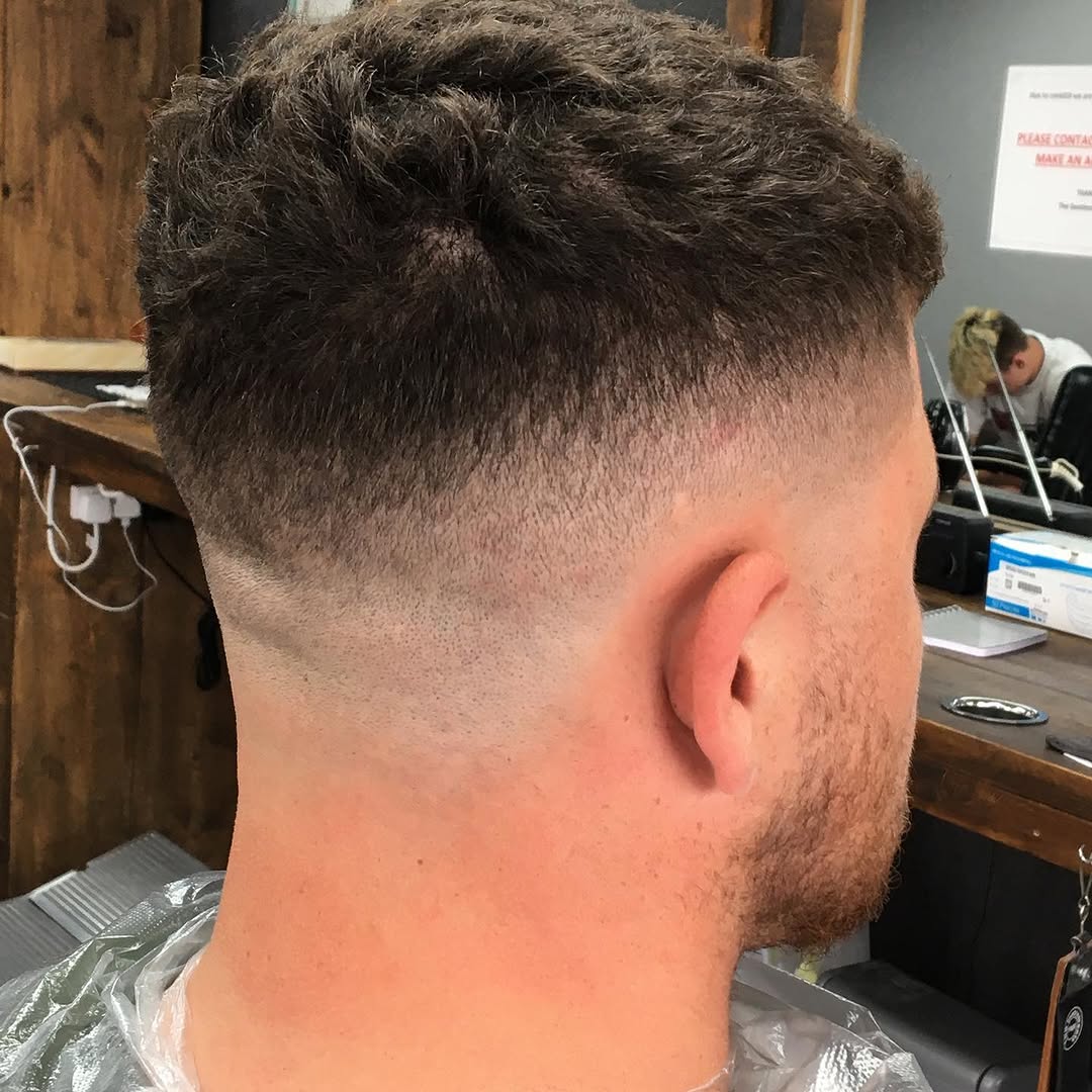 Recent barber cut with clean blended sides