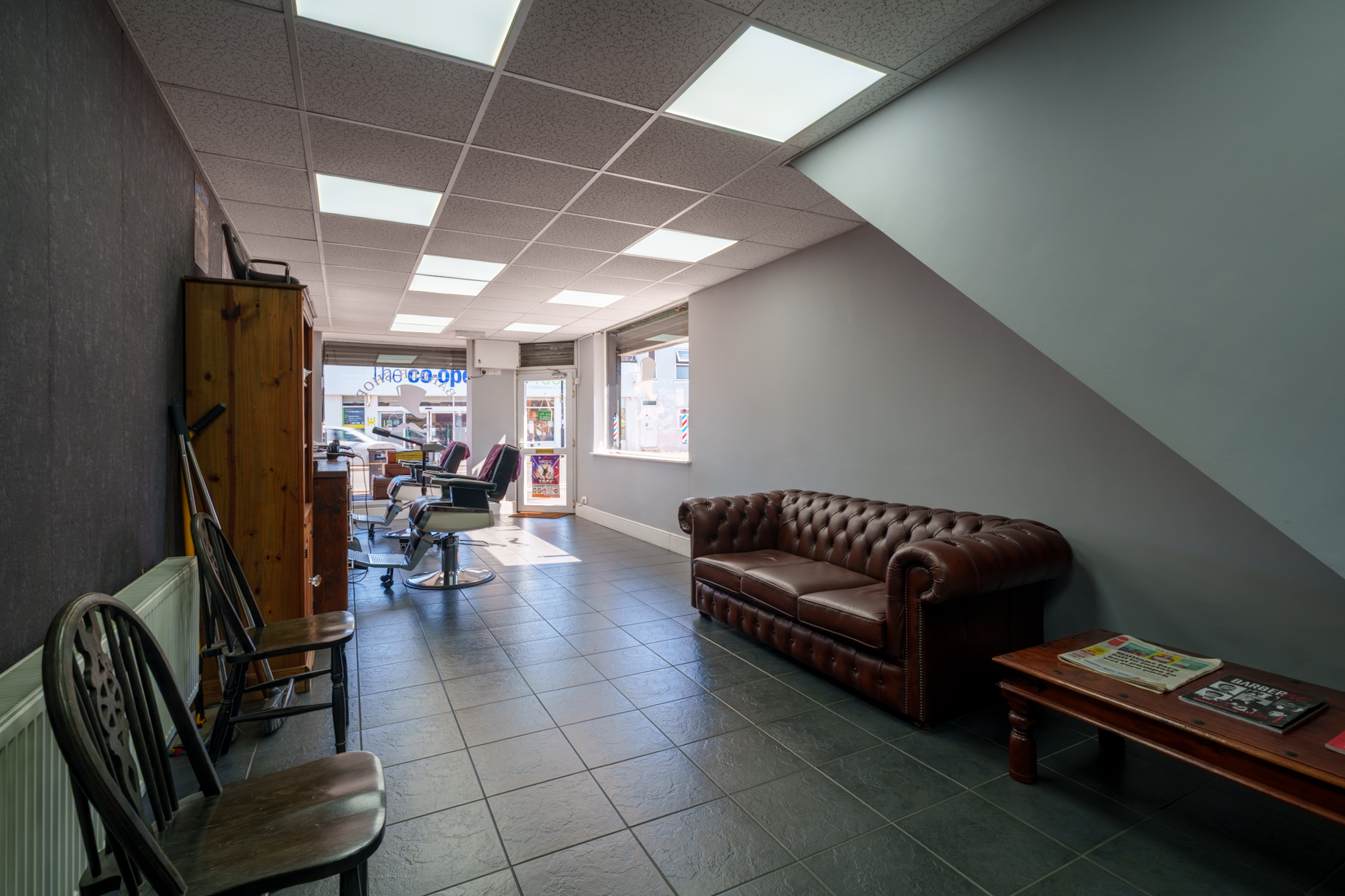 Wide shot of The Gentlemen's Barber Coventry shop interior with mirrors